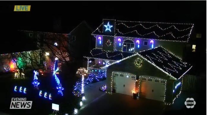 Front view of the Rusty Griswold Christmas Light Display in Burlington, Ontario, featuring synchronized lights, glowing decorations, and a live CHCH Evening News segment filmed on December 10, 2019.
